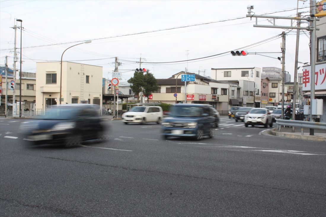 バスは阪神尼崎駅から西大島までは国道2号（阪神国道）を走り、西大島交差点で阪神国道（手前）から尼宝電鉄の線路敷を活用した兵庫県道42号（奥）に移る（筆者撮影）