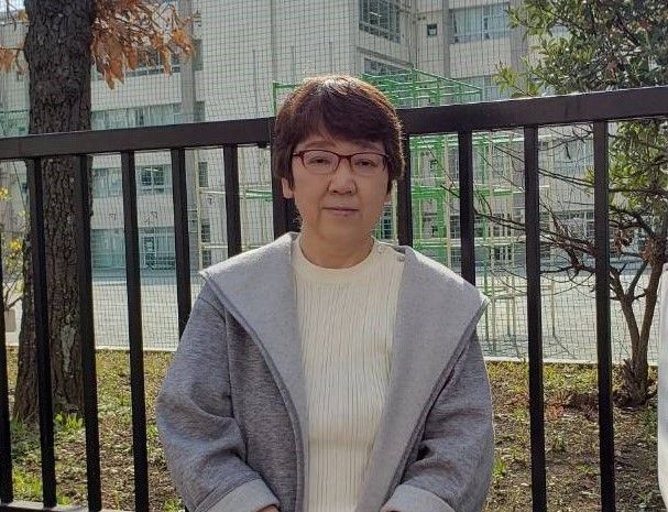 勤務していた小学校の前で（写真：小川さん提供）