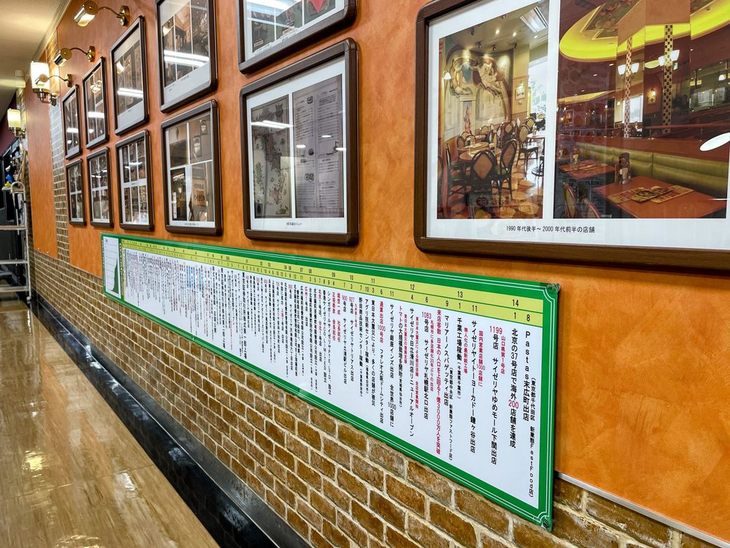 「サイゼリヤ 本八幡北口パティオ店」の外壁には歴史を伝える写真や年表が掲示されている（筆者撮影）