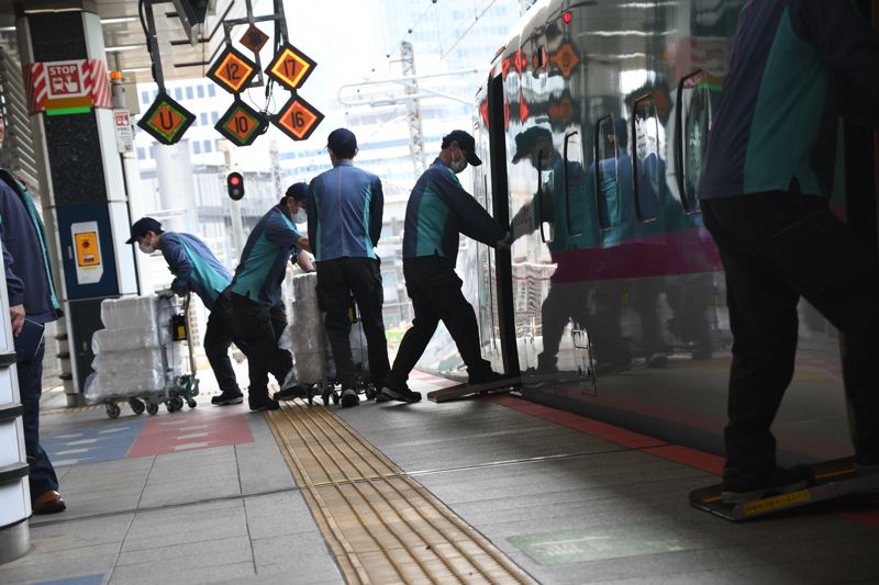 1号車の先頭のドアでも荷物が運び出されている（記者撮影）