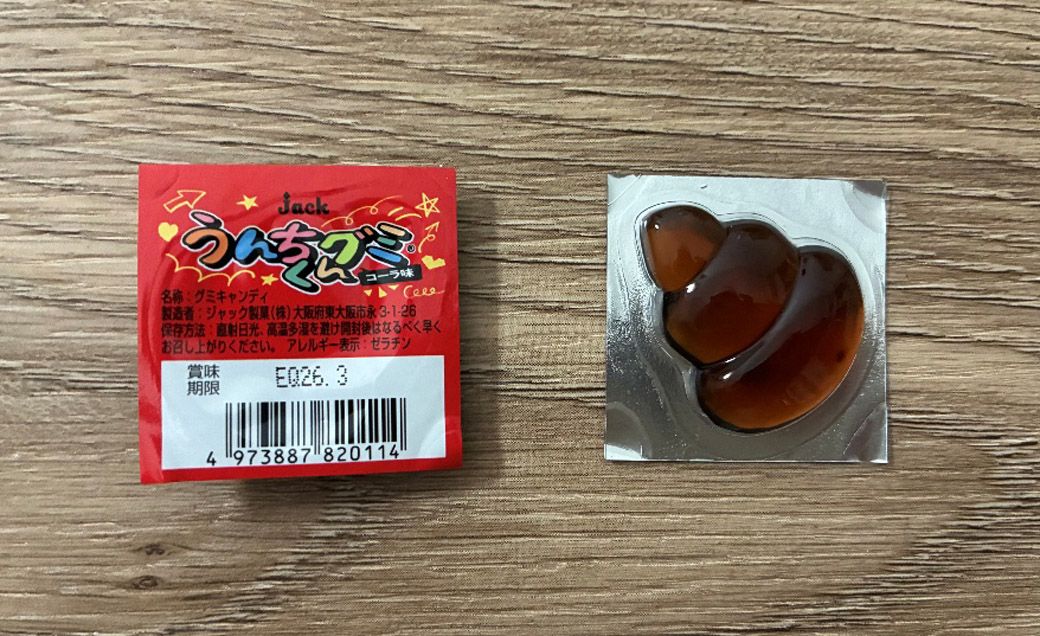『うんちくんグミ』に食品表示とバーコードを入れたもの。それだけで、フタの半分以上のスペースが埋まってしまっている（筆者撮影）