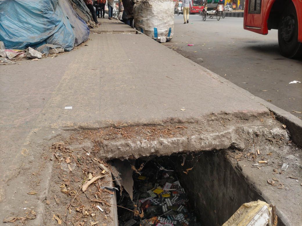 市内の歩道。大きな穴の中に大量の薬が落ちている（筆者撮影）